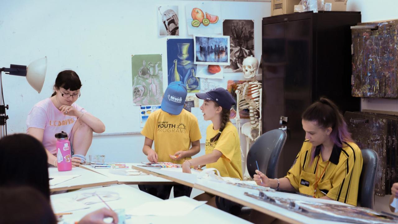 campers and counselors working on their drawings in the craft center.