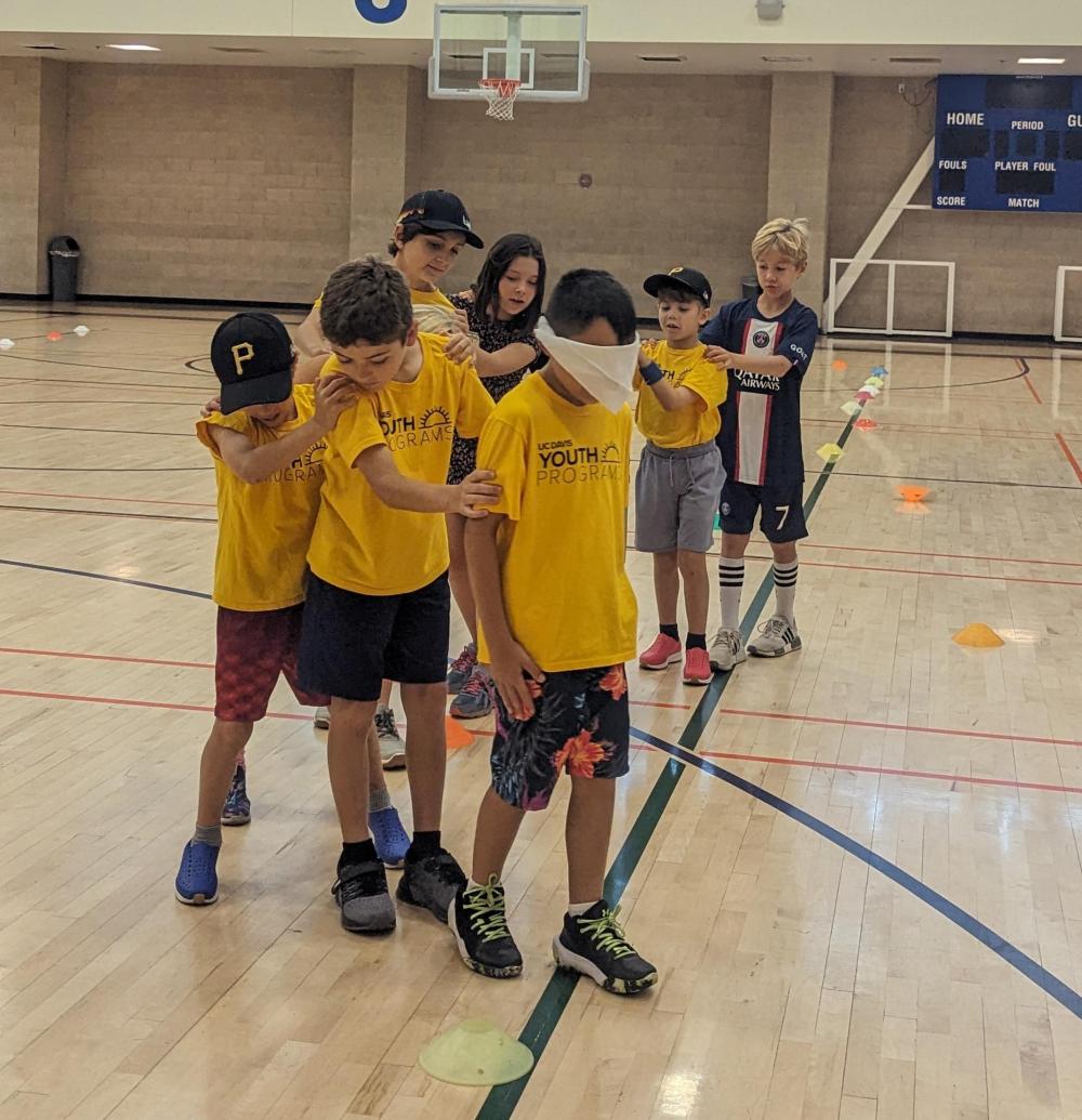 Campers form a line and direct their leader while they're blindfolded